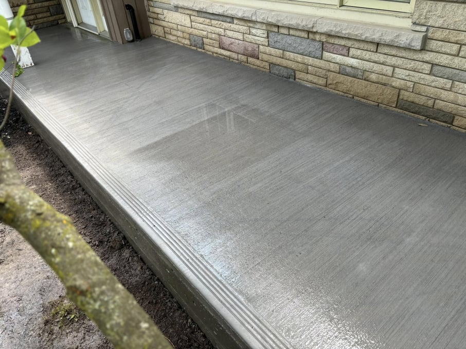 Finished concrete front porch slab with crisp edge detail