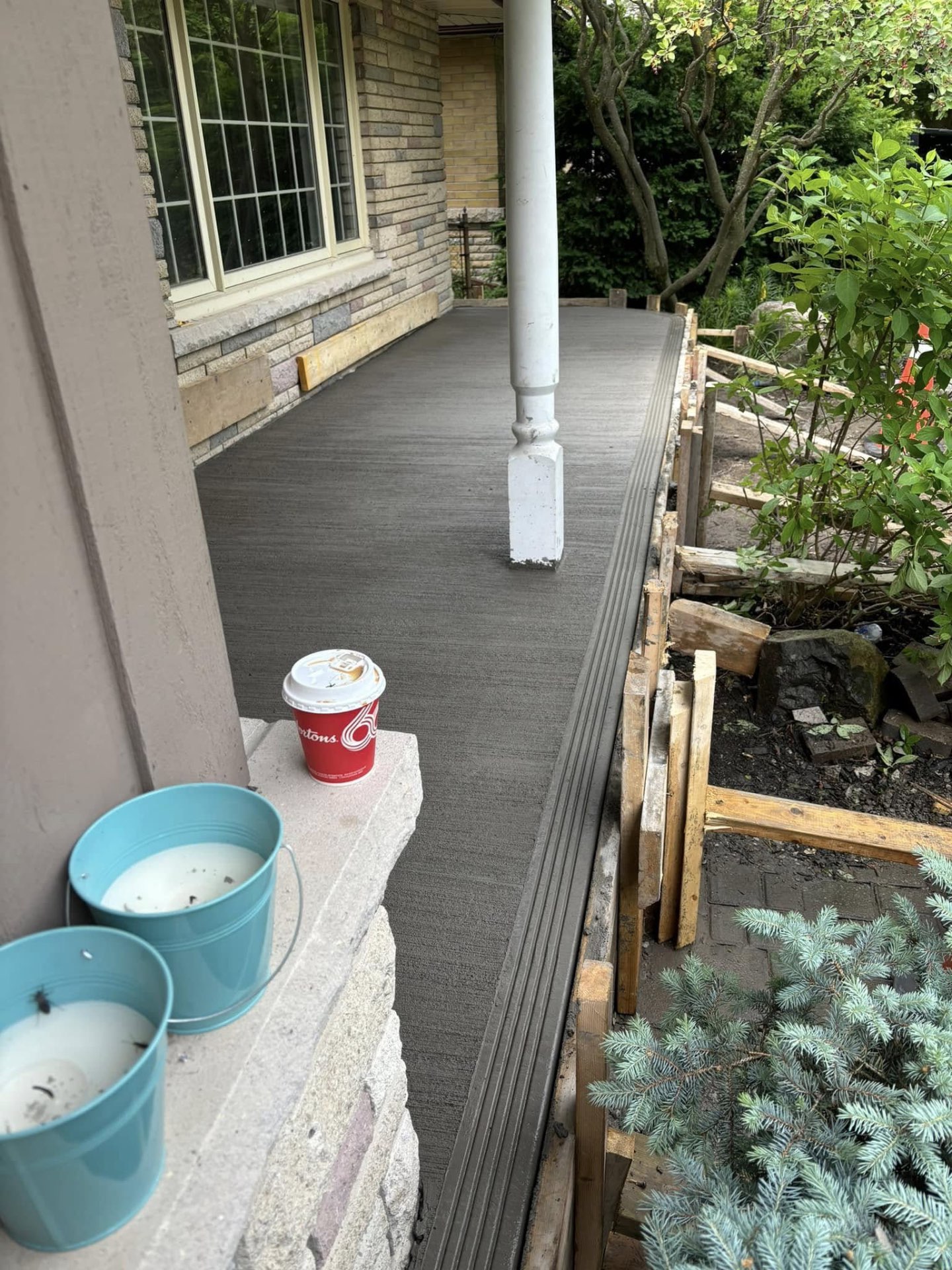 Wood formwork in place for a residential concrete porch pour